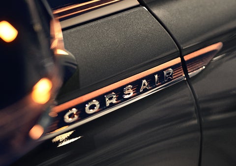 The stylish chrome badge reading “CORSAIR” is shown on the exterior of the vehicle. | Midland Lincoln in Midland MI