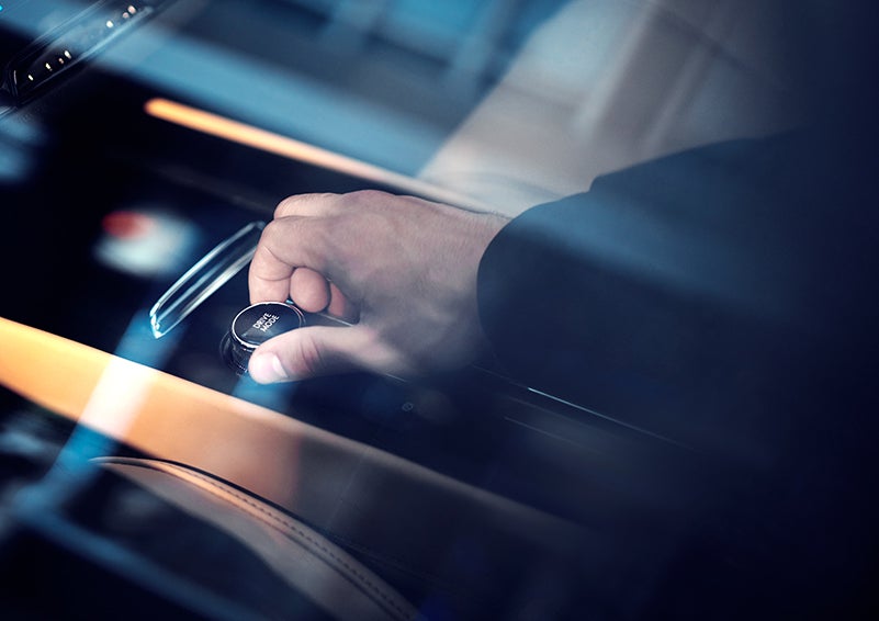 The driver of a 2023 Lincoln Corsair® SUV is shown adjusting the drive mode. | Midland Lincoln in Midland MI