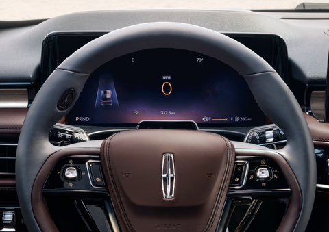 The steering wheel of 2025 Lincoln Aviator® SUV is shown with black and brown accents. | Midland Lincoln in Midland MI