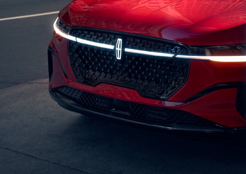 The available front LED light bar and center Lincoln Star logo glow at dusk. | Midland Lincoln in Midland MI