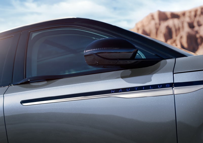 Blue lettering on the side of the vehicle that reads nautilus indicates the available hybrid powertrain. | Midland Lincoln in Midland MI