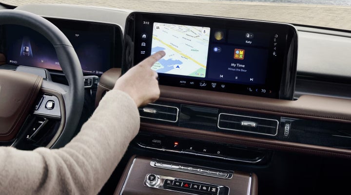 A person is tapping the center display touchscreen of a 2026 Lincoln Aviator® SUV. | Midland Lincoln in Midland MI