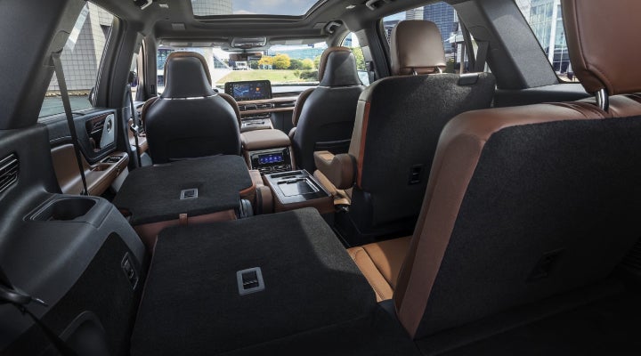 One side of the PowerFold® third-row seat and a second-row seat are folded forward in the 2026 Lincoln Aviator® SUV. | Midland Lincoln in Midland MI