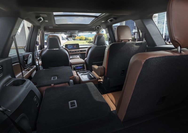 One side of the PowerFold® third-row seat and a second-row seat are folded forward in the 2026 Lincoln Aviator® SUV. | Midland Lincoln in Midland MI