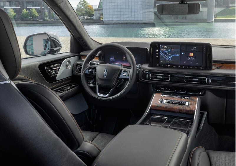 The interior of the 2026 Lincoln Aviator® SUV is shown parked with a view of a harbor through the windshield. | Midland Lincoln in Midland MI