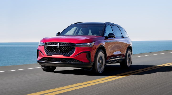 A 2026 Lincoln Nautilus® SUV is being driven on a seaside roadway. | Midland Lincoln in Midland MI