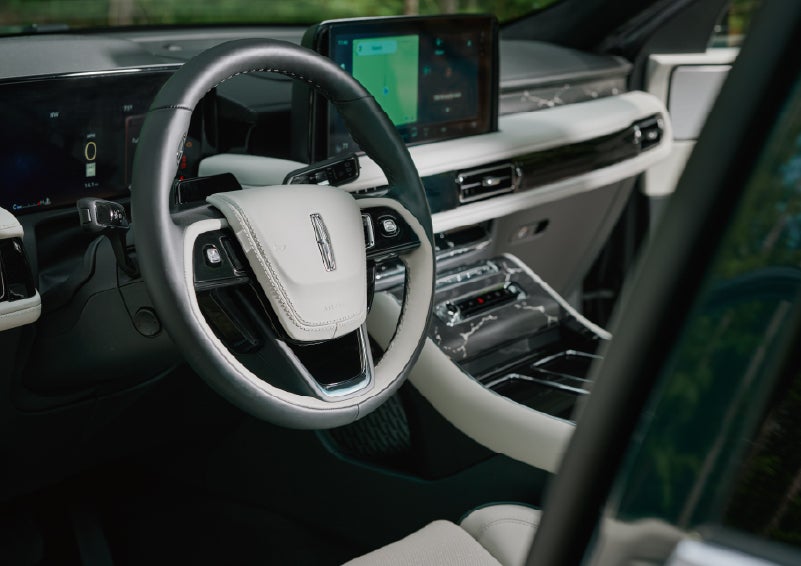 The leather-trimmed steering wheel of a 2027 Lincoln Aviator® Black Label™ SUV. | Midland Lincoln in Midland MI