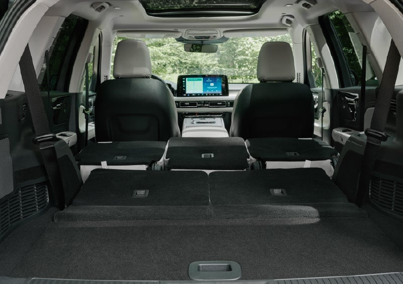A rear to front view of the interior of a 2027 Lincoln Aviator® Black Label™ SUV shows the third and second rows folded flat | Midland Lincoln in Midland MI