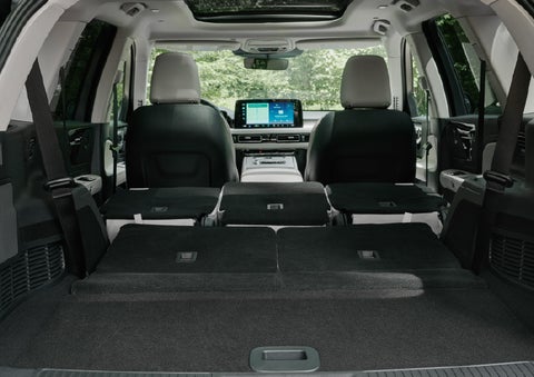 A rear to front view of the interior of a 2027 Lincoln Aviator® Black Label™ SUV shows the third and second rows folded flat | Midland Lincoln in Midland MI